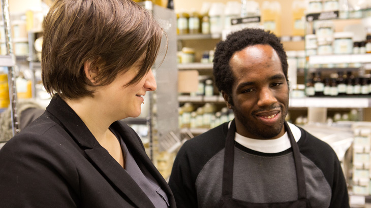 Man with autism working with female supervisor.